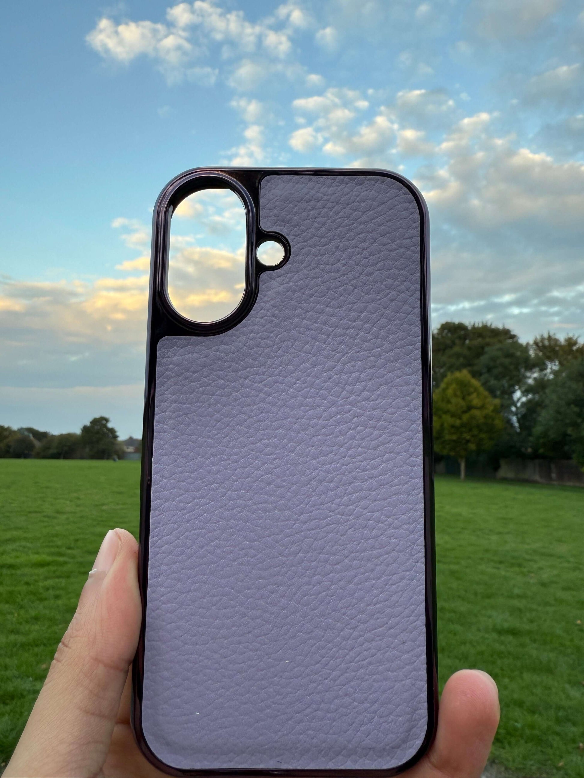 Premium Protection Kit iPhone 17 showcasing handcrafted leather iPhone pouch against a scenic outdoor backdrop.