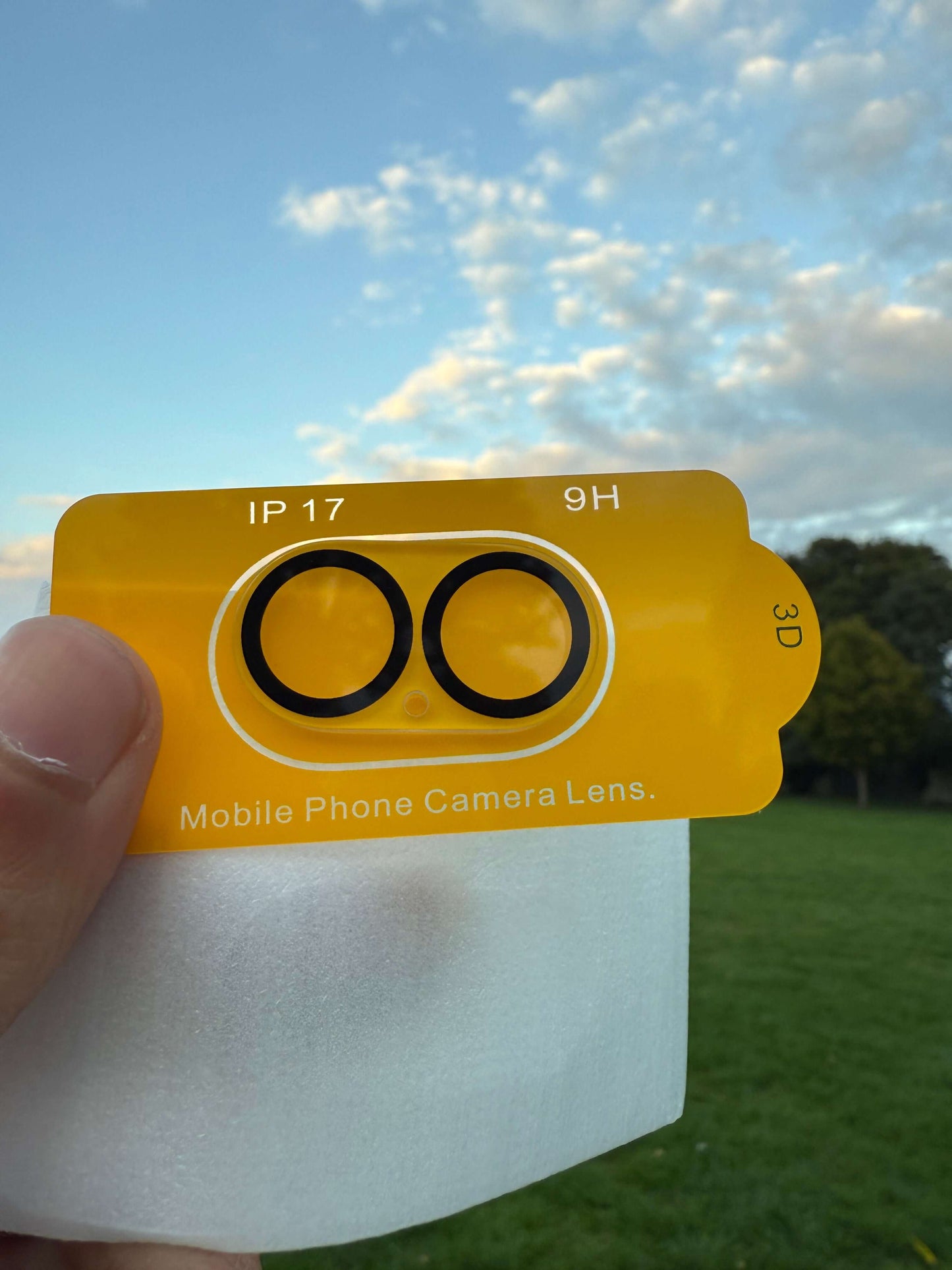 Premium Protection Kit iPhone 17 showcasing mobile phone camera lens on outdoor background.