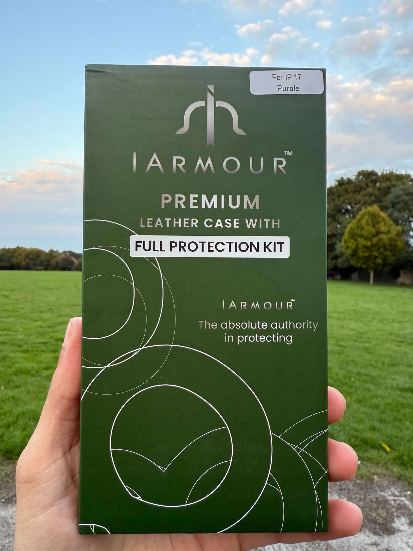 Premium Protection Kit iPhone 17 packaging with leather case for iPhone 17, showcasing style and durability in an outdoor setting.