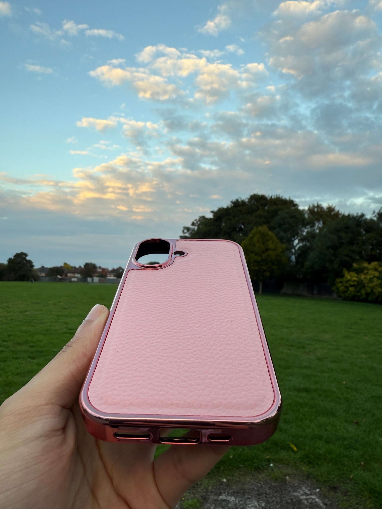 Premium Protection Kit iPhone 17 showcased in a holder, highlighting the elegant pink leather design in a natural setting.